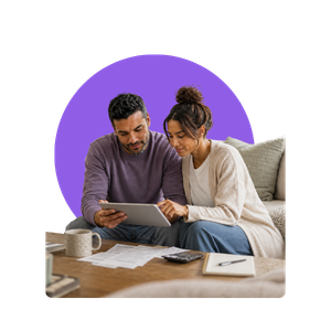 couple on couch looking at laptop