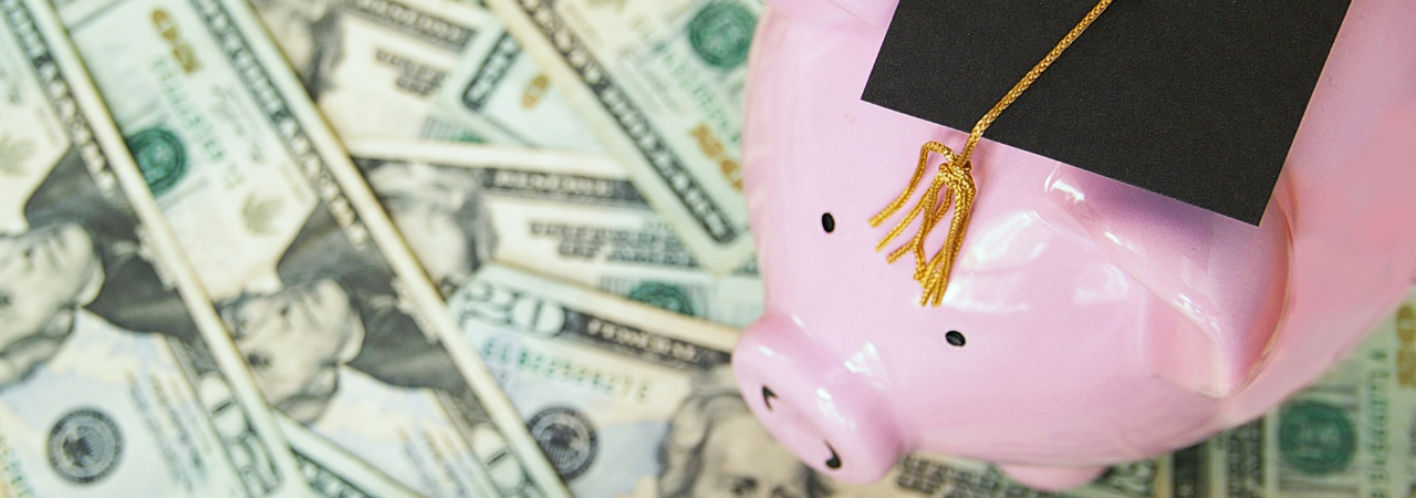 money with a piggy bank wearing a college graduation cap