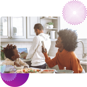 family enjoying a meal while on mobile banking app